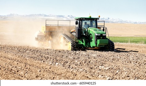 American Falls, Idaho, USA Apr. 17, 2015 A Tractor In The Field Planting Potatoes