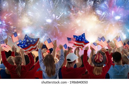 American family celebrating 4th of July. People watching Independence Day fireworks holding US flag. Proud USA crowd cheer and celebrate. Group with America symbol. National holiday party.