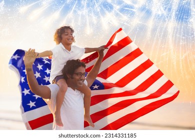 American family celebrating 4th of July. People watching Independence Day fireworks holding US flag. Proud USA crowd cheer and celebrate. Group with America symbol. National holiday party. - Powered by Shutterstock