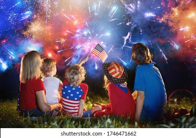 American Family Celebrating Independence Day. Picnic And Fireworks On 4th Of July In America. USA Flag. Parents And Kids Celebrate US Holiday. Children Watching Firework.