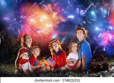 American Family Celebrating Independence Day. Picnic And Fireworks On 4th Of July In America. USA Flag. Parents And Kids Celebrate US Holiday. Children Watching Firework.