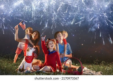 American family celebrating Independence Day. Picnic and fireworks on 4th of July in America. USA flag. Parents and kids celebrate US holiday. Children watching firework. - Powered by Shutterstock