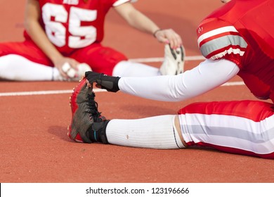 American female soccer players performing pregame stretching