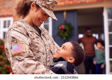 American Female Soldier In Uniform Returning Home To Family On Hugging Children Outside House - Powered by Shutterstock