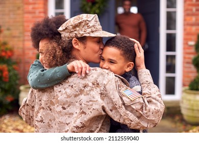 American Female Soldier In Uniform Returning Home To Family On Hugging Children Outside House - Powered by Shutterstock