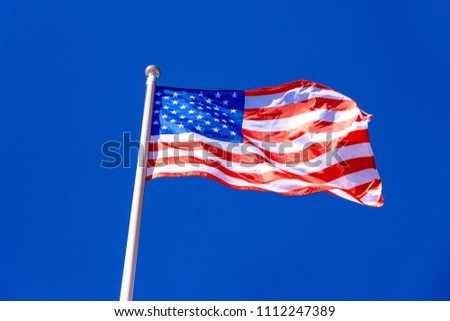 American Flag against blue sky.