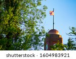 American Flag Atop Fifth Third Bank Clock Tower at North Union Street and West Front Street. Located in West Traverse City Bay Area, MI. Clear Blue Summer Day.