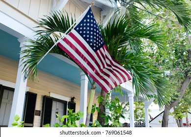 American Flag Attached To Porch Of House