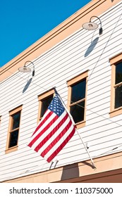 American Flag Attached To A Small Town Building In The USA