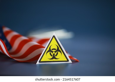 American flag and biohazard sign. The concept of American biolabs research centers.