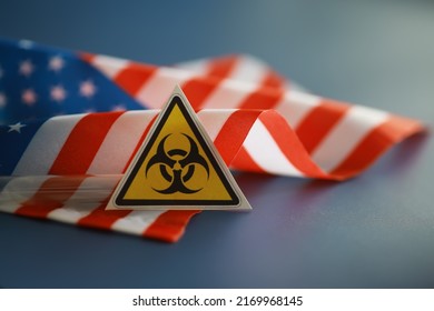 American flag and biohazard sign. The concept of American biolabs research centers.