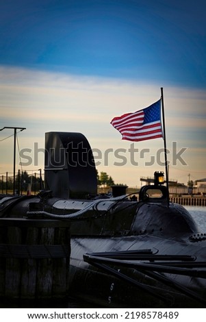 An American flag blows in the wind on the stern of a World War Two submarine preserved on a Wisconsin river.