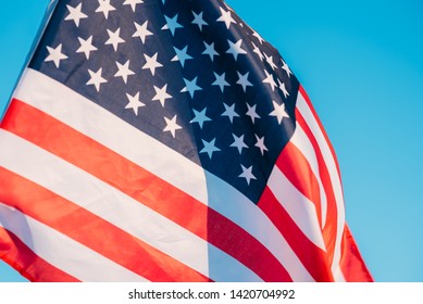 American Flag In Blue Sky. Close Up. Symbol Of Independence Day Fourth Of July In USA