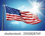 American flag in blue sky and sunshine background	