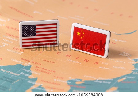 American flag and Chinese flag over world map