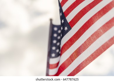 American flag close up against blue sky with clouds - Shutterstock ID 647787625