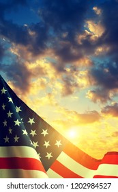 American Flag With Colorful Sunset Sky At The Background.