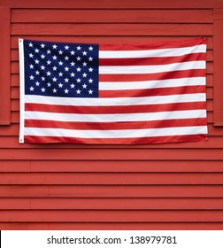 American flag displayed on red wooden wall