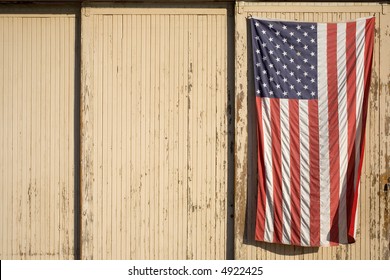 American flag displayed on the side of an old building