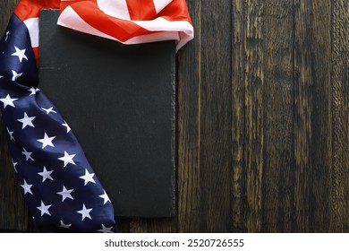 American Flag Draped on Blank Slate with Wooden Background, Patriotic Decoration for National Celebrations and Holidays - Powered by Shutterstock