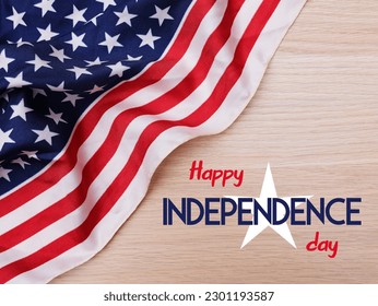 American flag draped on a wooden background. Text Happy independence day.