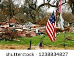 American flag flies amid hurricane damaged debris