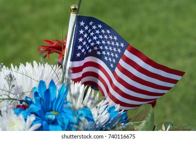 American Flag And Flowers On Grave For Memorial Day