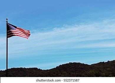 American Flag Flying in Hilly Landscape
