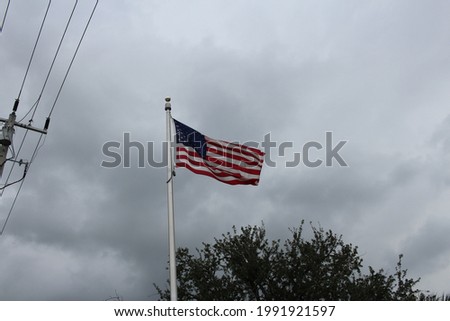 American flag flying in the overcast sky