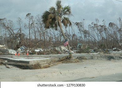 American Flag In Front Of Demolished Buildings In The Aftermath Of Hurricane Michael In Mexico Beach Florida