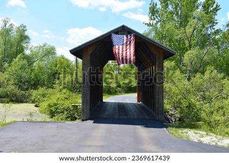 American flag hanging from a covered bridge in Northern Michigan.