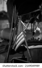 American Flag Hanging Down From A Boat In Black And White.