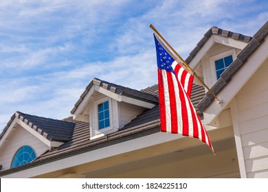 American Flag Hanging From House Facade.
