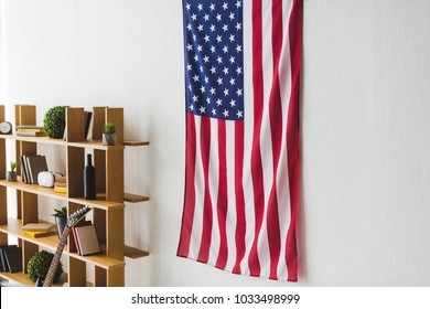 American Flag Hanging On Wall Inside Living Room 