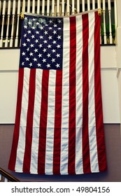 An American Flag hanging from a staircase on an office wall