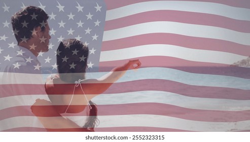 American flag image over couple embracing and looking at ocean. Patriotism, love, romance, unity, celebration, Americana - Powered by Shutterstock