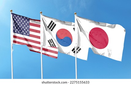 American flag with Japan flag and South Korea flag on cloudy sky. waving in the sky