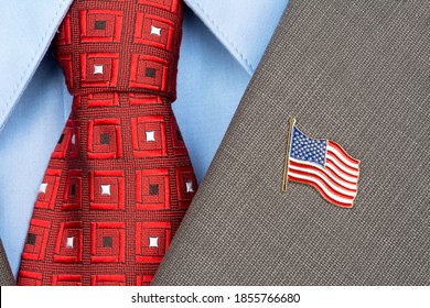 An American Flag Lapel Pin On The Collar Of A Business Suit Jacket Shows Patriotism