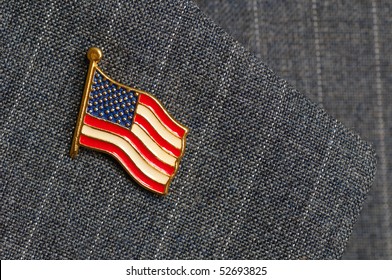 An American Flag Lapel Pin On A Pinstripe Suit Lapel