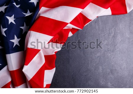 The American flag lies in an arc on a gray background