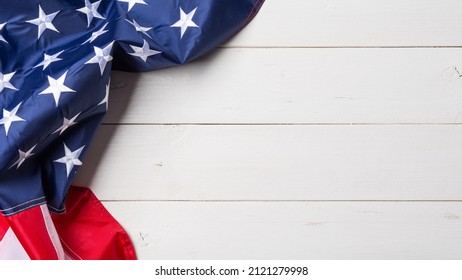 American flag lying on old white wooden background - Powered by Shutterstock