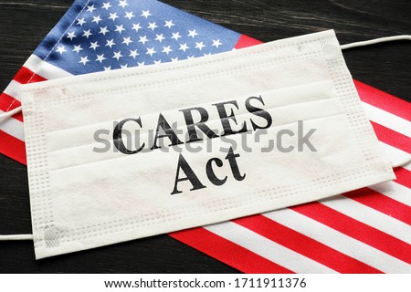 American flag and mask with sign cares act. Coronavirus Aid, Relief, and Economic Security law concept.
