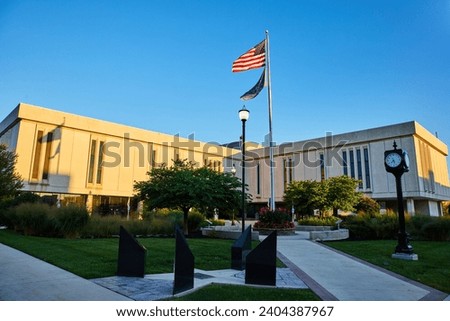 American Flag and Modern Courthouse at Sunrise with Garden