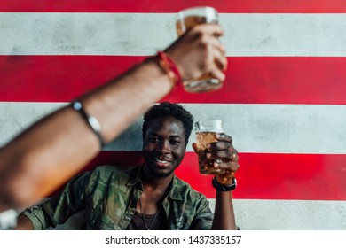 American Flag In Modern Gastropub..Mans Holding Beer.