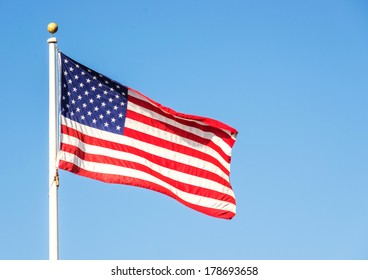 American Flag On The Blue Sky