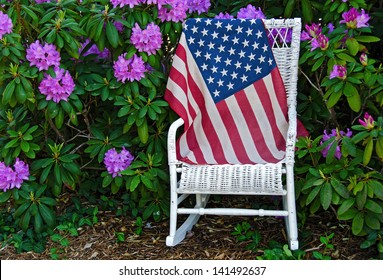 American flag on a chair in rhododendron garden