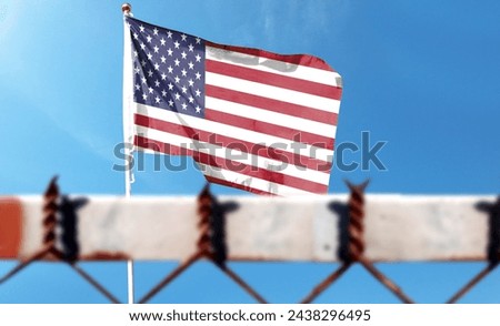 American flag on cloudy sky. Flying in the sky (the foreground is intentionally blurred) [[stock_photo]] © 