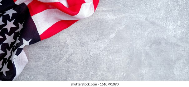 American flag on concrete stone background with copy space. Banner template for USA Memorial day, Presidents day, Veterans day, Labor day, or 4th of July celebration.