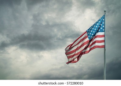 American Flag On A Dark Cloudy Dramatic Sky