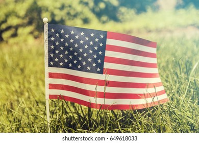 American flag on grass. close up. Waving american flag - Shutterstock ID 649618033